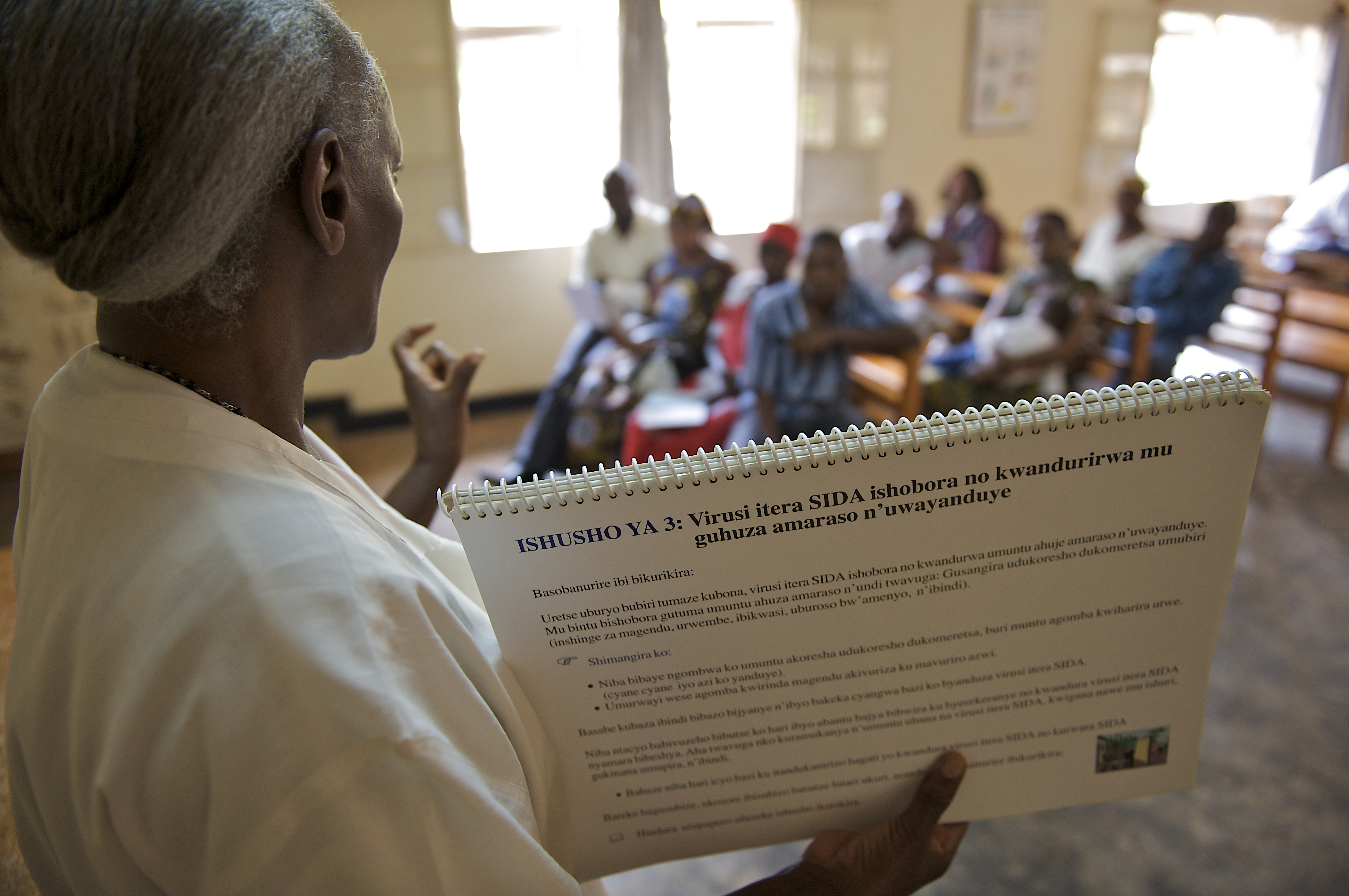 During a PMTCT counseling session, a female facilitator speaks to a group of couples before HIV tests are conducted at a UNICEF supported VCT clinic (voluntary counseling and testing) at Kicukiro Health Centre in Kigali, Rwanda.  