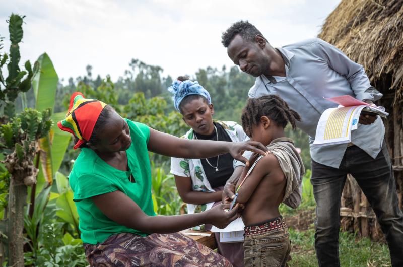 A community health worker assesses a child in Liberia